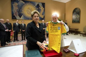 Pope Francis holds a soccer jersey received as a gift from Brazil's President Dilma Rousseff during a meeting at the Vatican